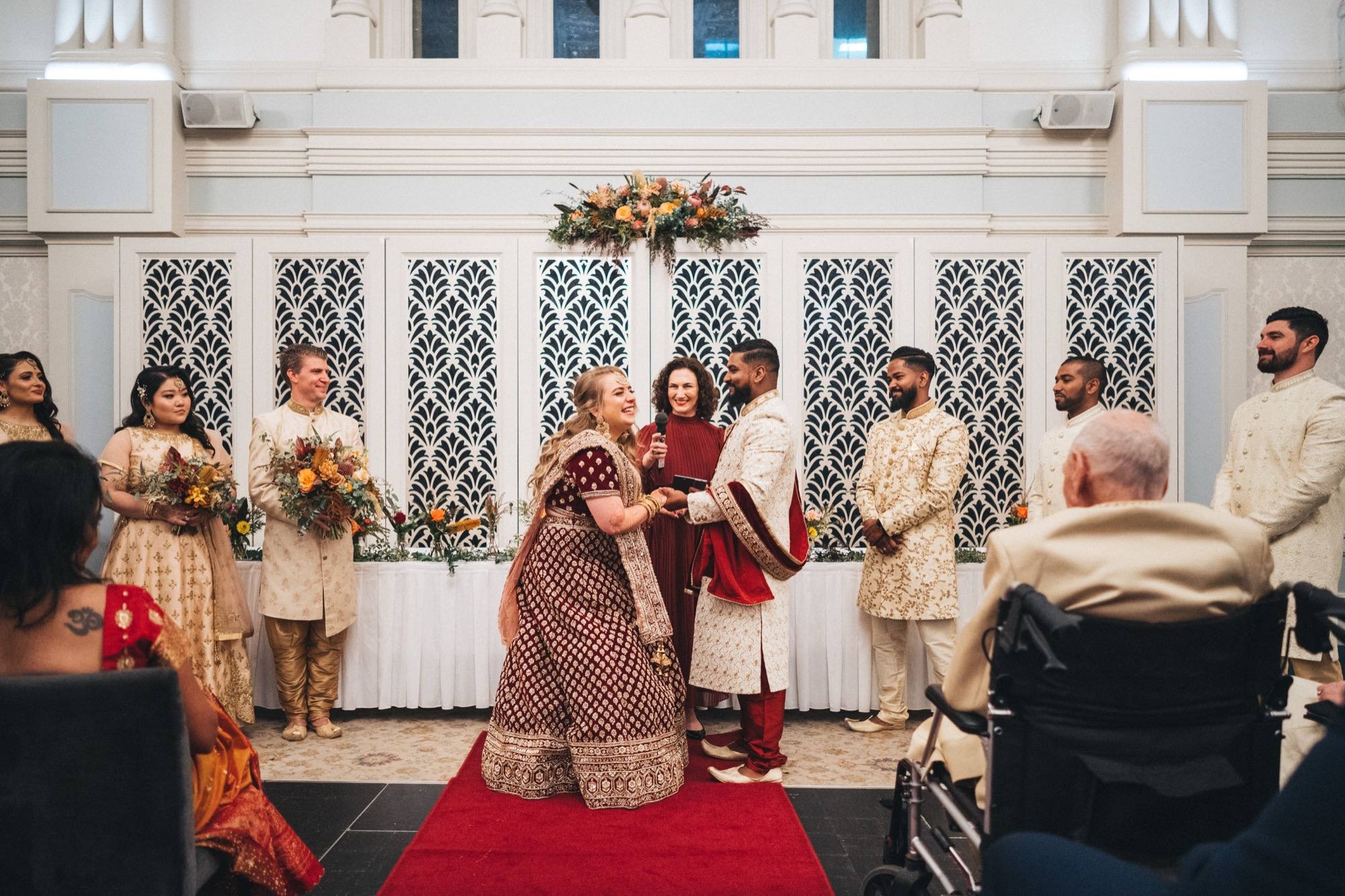 Two people embracing on the aisle at a South Asian wedding ceremony conducted by celebrant Melissa Soncini